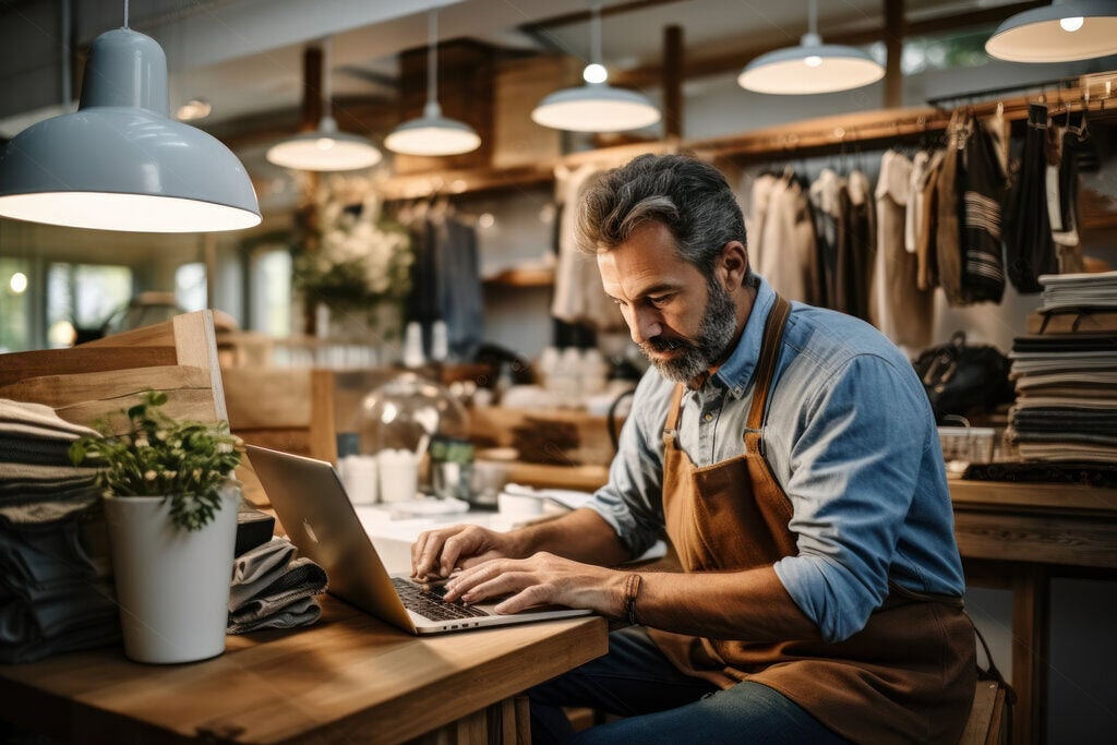 A small business owner checks his business account online.